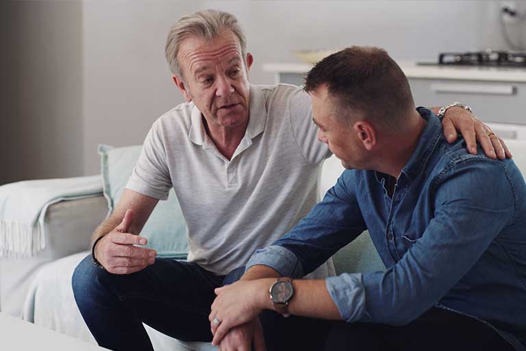 Older man offering support to younger man
