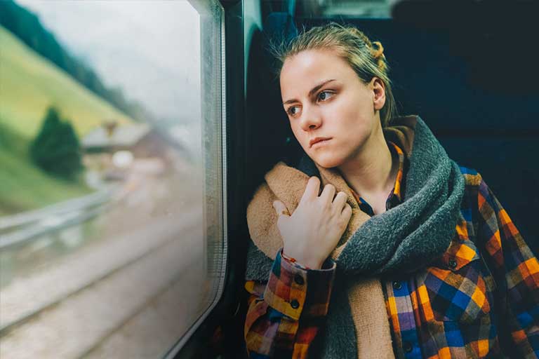 young girl looking out train window